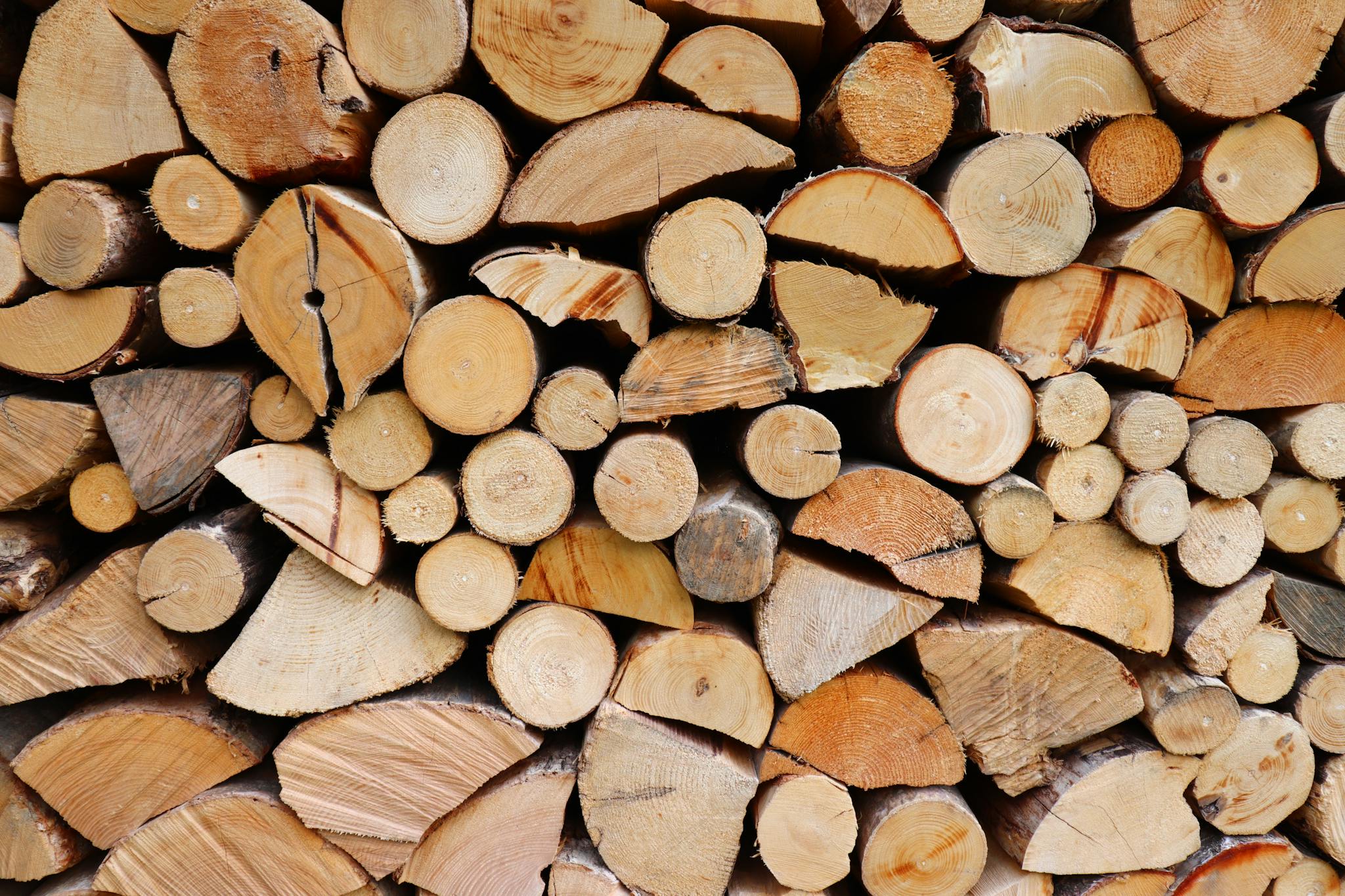 Close-up view of stacked firewood logs, perfect for rustic home heating.